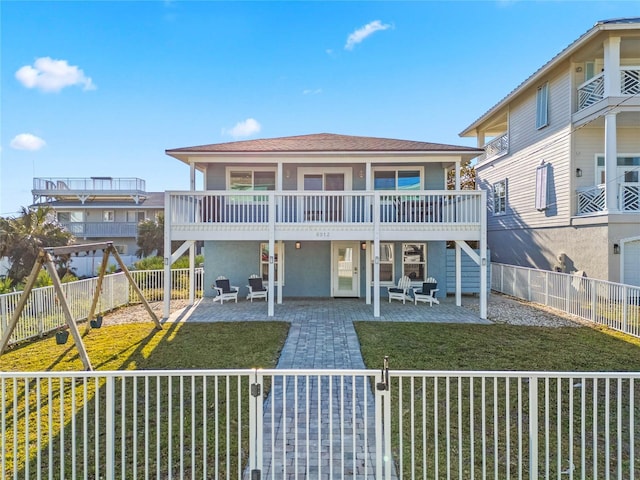 rear view of house with a fenced backyard and a patio