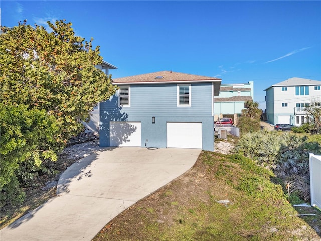 view of home's exterior featuring an attached garage, stucco siding, and concrete driveway