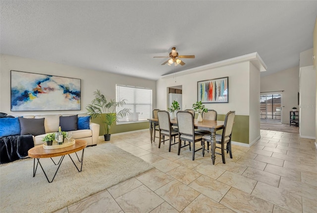 dining space with a textured ceiling and ceiling fan