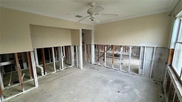 empty room featuring crown molding and ceiling fan