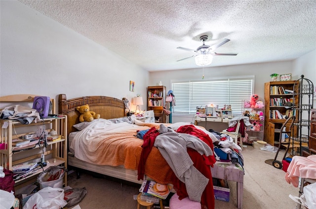 carpeted bedroom featuring ceiling fan and a textured ceiling