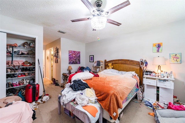 bedroom with ceiling fan, a closet, and a textured ceiling