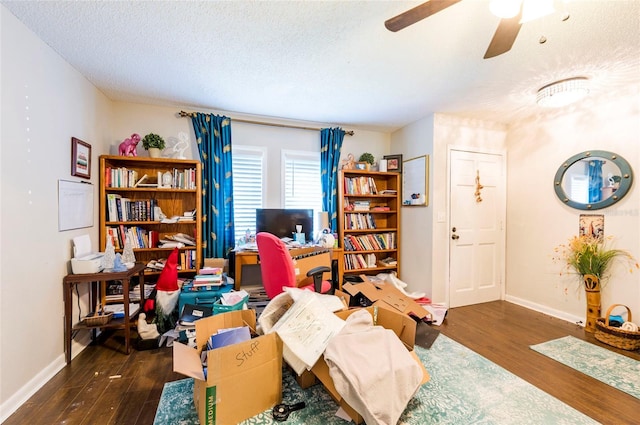 office area featuring ceiling fan, dark wood-type flooring, and a textured ceiling