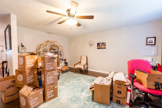 bedroom featuring hardwood / wood-style flooring, a textured ceiling, and ceiling fan