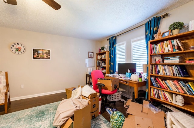 office space featuring ceiling fan, dark hardwood / wood-style floors, and a textured ceiling