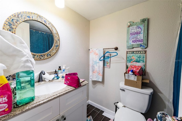 bathroom featuring vanity and toilet