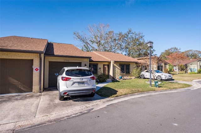 single story home featuring a garage and a front yard