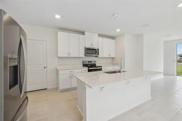 kitchen with a sink, recessed lighting, a kitchen island with sink, and stainless steel appliances