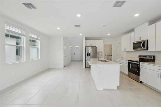 kitchen with visible vents, recessed lighting, stainless steel appliances, and a sink