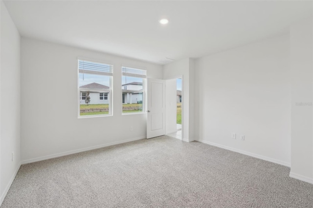 empty room with recessed lighting, baseboards, and carpet floors