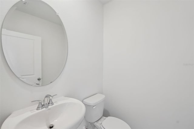 bathroom featuring toilet and a sink