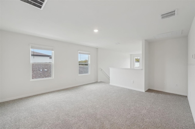 carpeted spare room featuring visible vents, recessed lighting, and baseboards