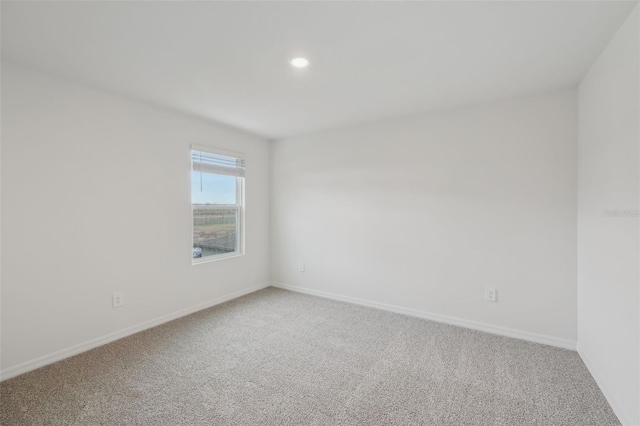 unfurnished room featuring recessed lighting, baseboards, and carpet floors