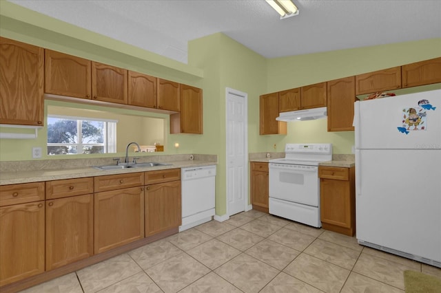 kitchen featuring vaulted ceiling, white appliances, sink, and light tile patterned floors