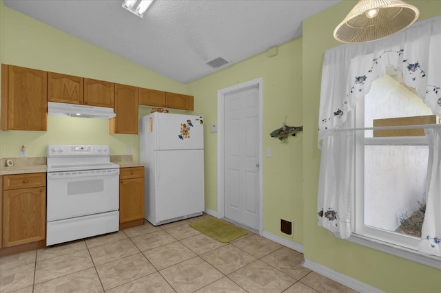 kitchen with white appliances, vaulted ceiling, a textured ceiling, and light tile patterned floors