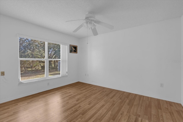 unfurnished room featuring ceiling fan, a textured ceiling, and light wood-type flooring