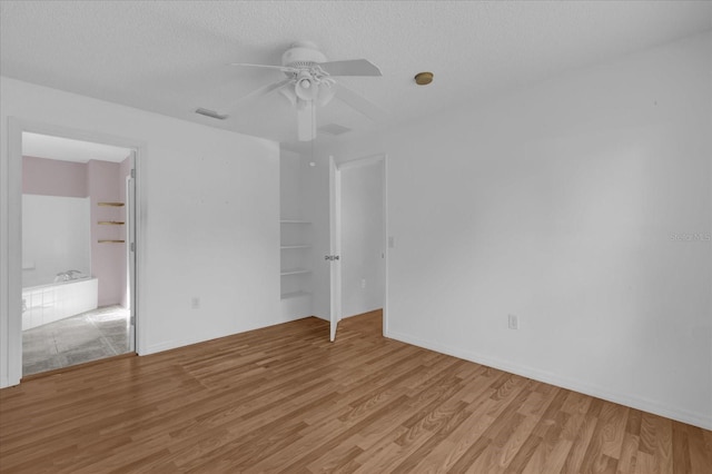 unfurnished bedroom featuring a textured ceiling, light hardwood / wood-style flooring, and ceiling fan