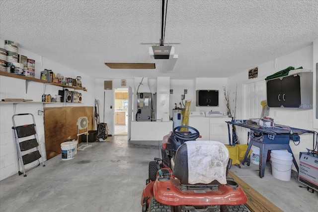 garage featuring a garage door opener, washer and clothes dryer, electric water heater, and heating unit