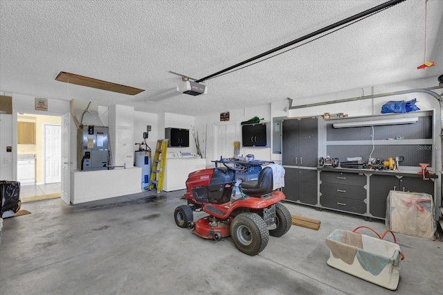 garage featuring heating unit, a garage door opener, electric panel, and electric water heater