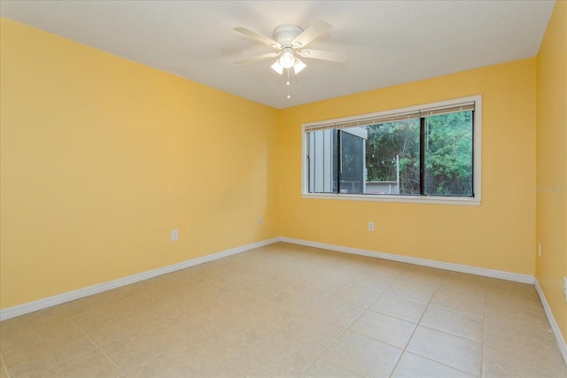 empty room featuring ceiling fan and light tile patterned floors