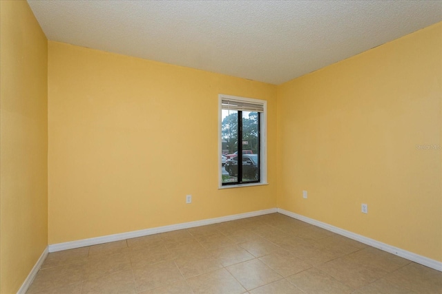 unfurnished room with a textured ceiling