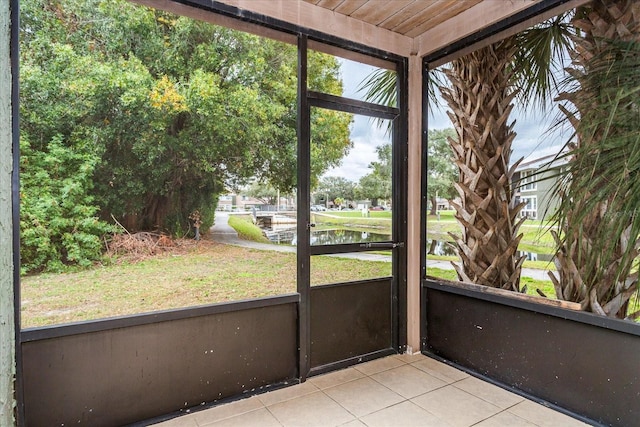 unfurnished sunroom with a water view