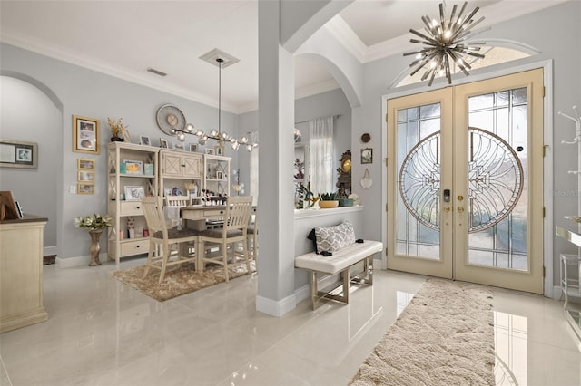 entrance foyer featuring french doors, a wealth of natural light, crown molding, and a notable chandelier