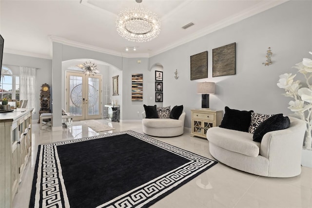 living room with crown molding, a chandelier, and french doors