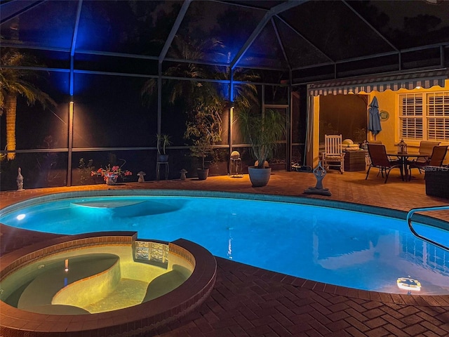 view of pool featuring an in ground hot tub, a patio, and glass enclosure