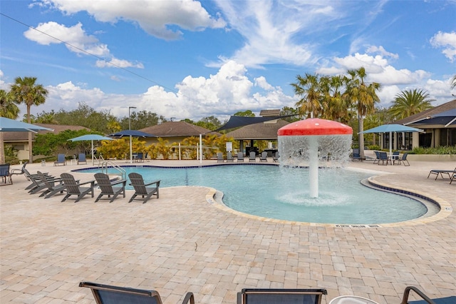 view of swimming pool with pool water feature