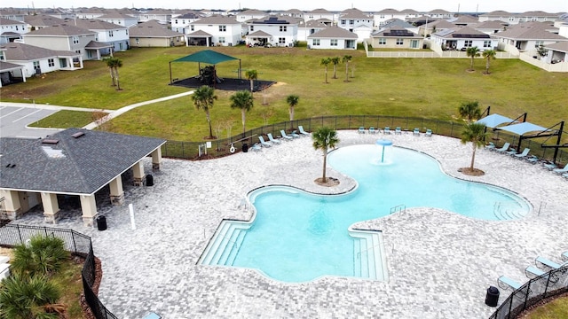 view of pool featuring pool water feature and a yard