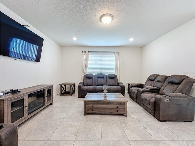 tiled living room featuring a textured ceiling