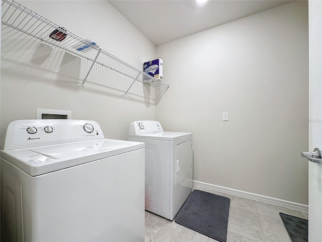 clothes washing area featuring separate washer and dryer