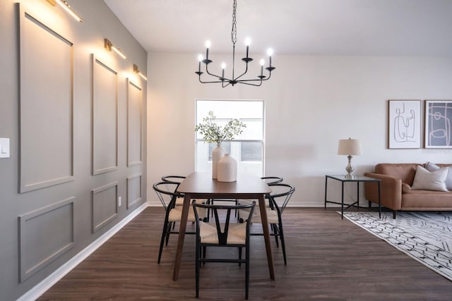 dining area featuring dark hardwood / wood-style flooring and a chandelier