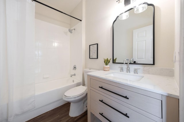 full bathroom with vanity, hardwood / wood-style floors, shower / bathtub combination, and toilet