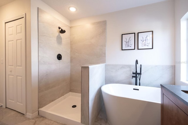 bathroom featuring independent shower and bath and vanity