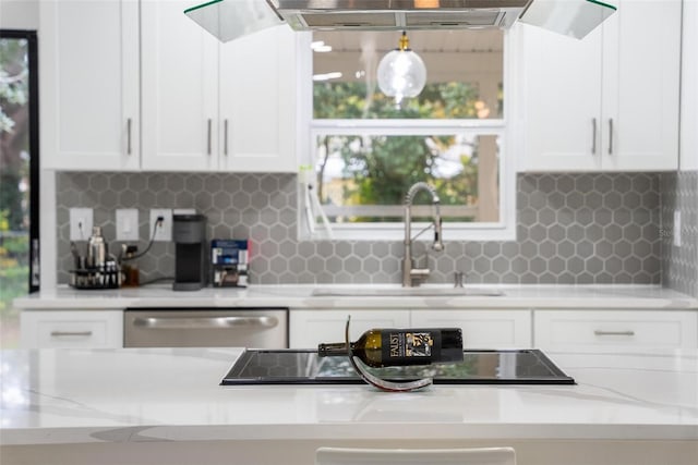 kitchen featuring sink, white cabinetry, stainless steel dishwasher, light stone countertops, and range hood