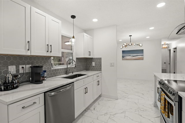 kitchen featuring pendant lighting, sink, white cabinetry, stainless steel appliances, and light stone counters