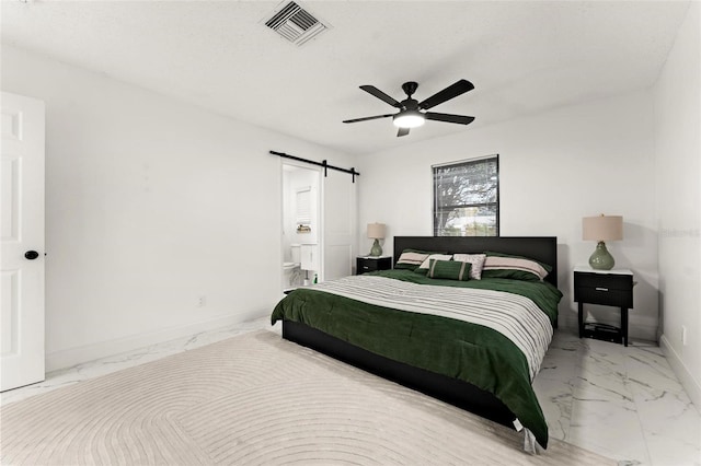 bedroom with connected bathroom, a barn door, and ceiling fan