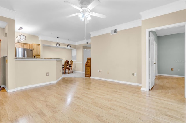 unfurnished living room featuring crown molding, ceiling fan, and light hardwood / wood-style floors