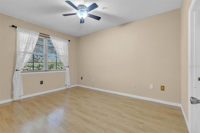 spare room with ceiling fan and light wood-type flooring