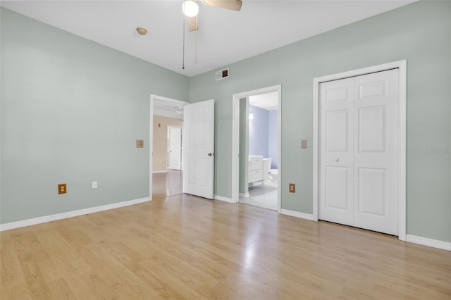 unfurnished bedroom with ceiling fan, ensuite bath, a closet, and light hardwood / wood-style flooring