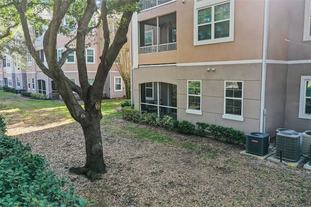 back of house featuring central AC unit