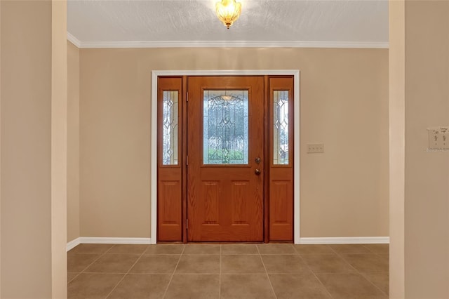 foyer entrance featuring ornamental molding, tile patterned floors, and a textured ceiling