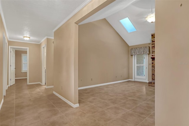 interior space featuring light tile patterned floors, crown molding, and lofted ceiling with skylight