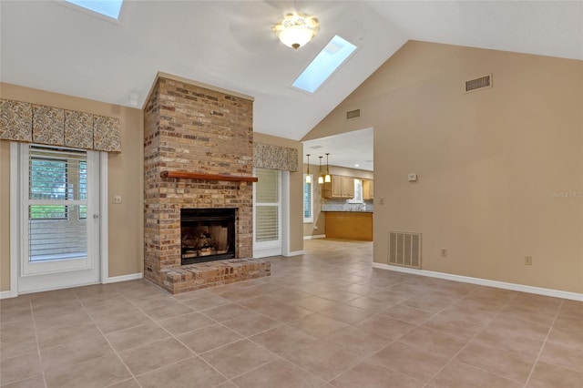 unfurnished living room featuring light tile patterned floors, a skylight, a fireplace, and high vaulted ceiling