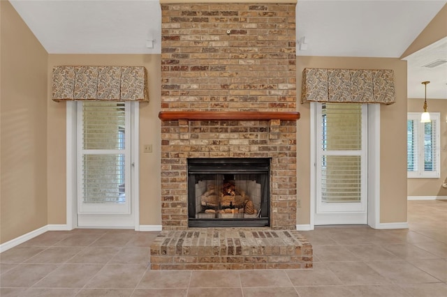 interior space with vaulted ceiling, tile patterned floors, and a fireplace