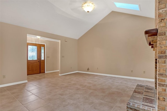 tiled foyer featuring lofted ceiling with skylight