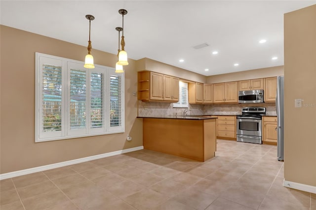 kitchen featuring appliances with stainless steel finishes, pendant lighting, decorative backsplash, kitchen peninsula, and light brown cabinets