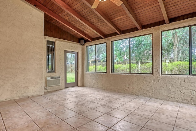 unfurnished sunroom featuring ceiling fan, vaulted ceiling with beams, wood ceiling, and a wall unit AC